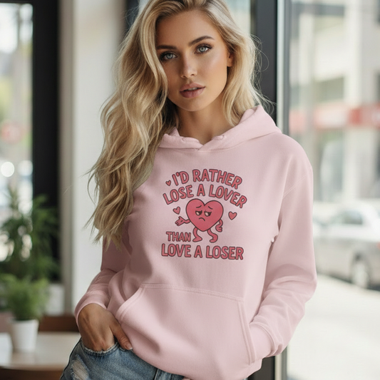 Woman wearing a pink empowerment hooded sweatshirt that says I’d rather lose a lover than love a loser