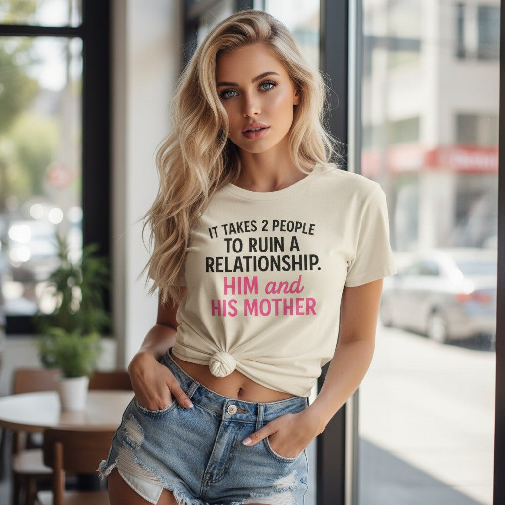 Woman wearing a beige funny breakup t-shirt with pink text saying it takes 2 people to ruin a relationship him and his mother