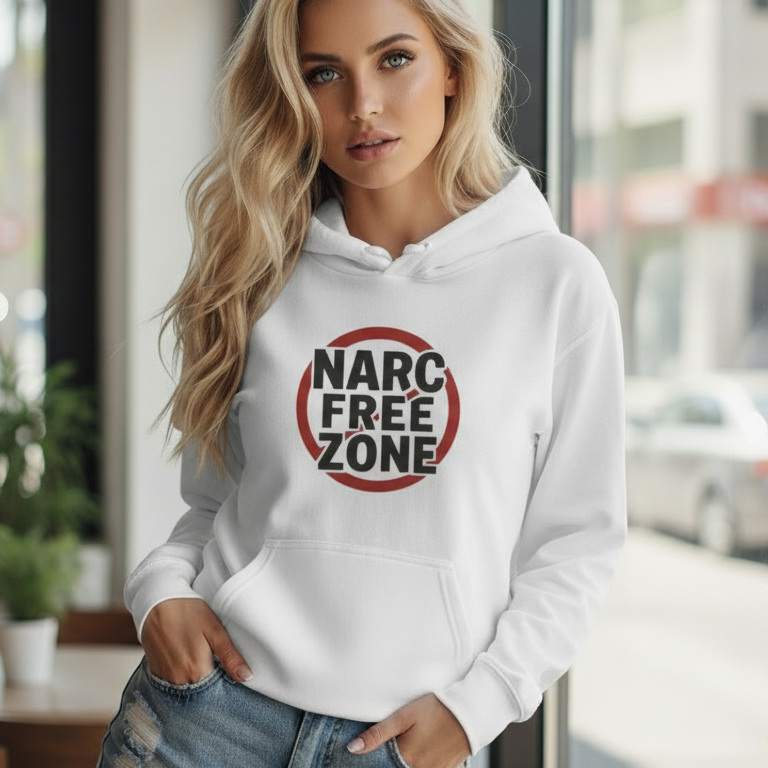 Woman wearing a white empowerment hooded sweatshirt with the quote narc free zone