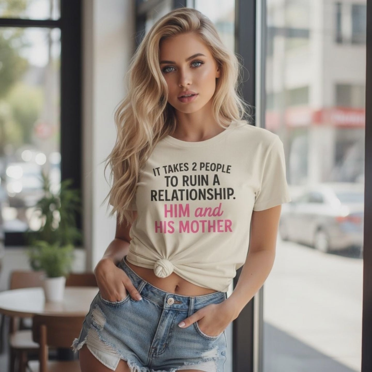 Woman wearing a beige funny breakup t-shirt with pink text saying it takes 2 people to ruin a relationship him and his mother video