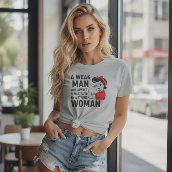 Blonde woman wearing a black empowerment t-shirt that says “A weak man will always be frustrated by a strong woman video