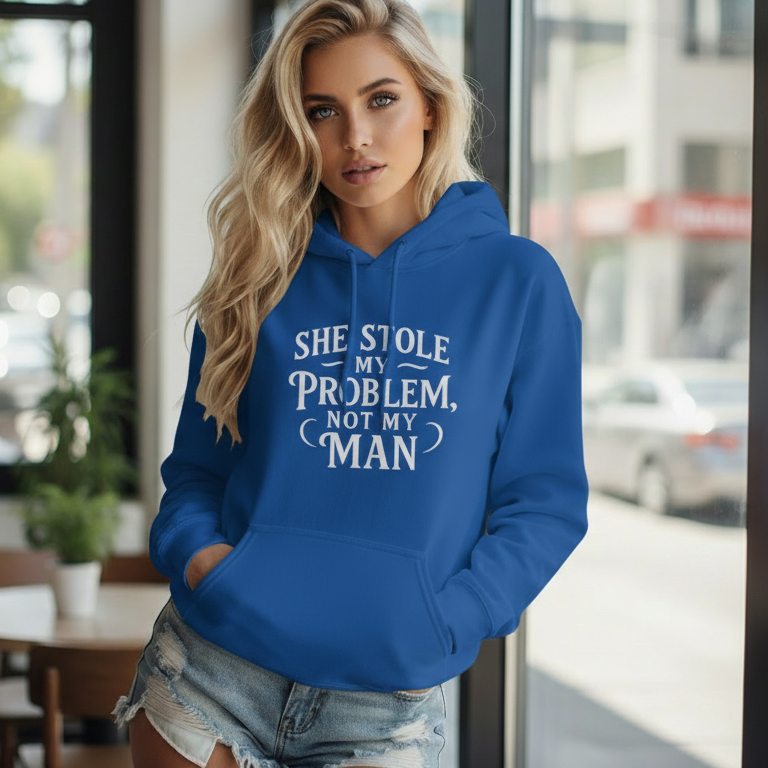 Woman wearing a blue empowerment hooded sweatshirt that says She Stole My Problem Not My Man